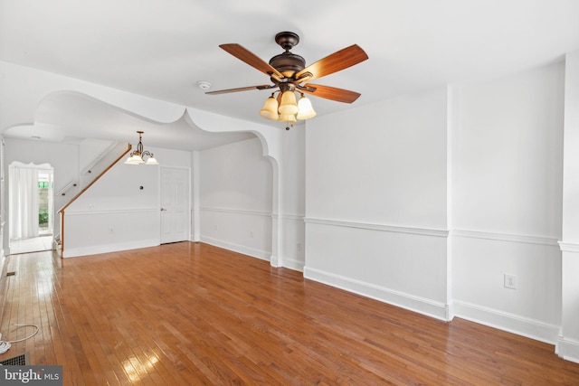 interior space with hardwood / wood-style floors and ceiling fan with notable chandelier