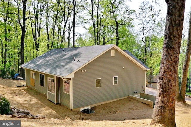 view of side of property featuring roof with shingles