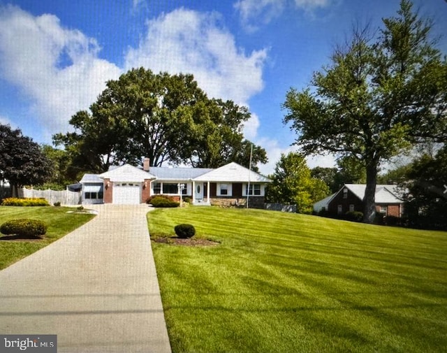 single story home featuring a garage and a front yard