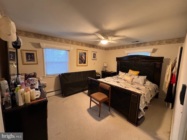 bedroom with light carpet, ceiling fan, and a baseboard heating unit