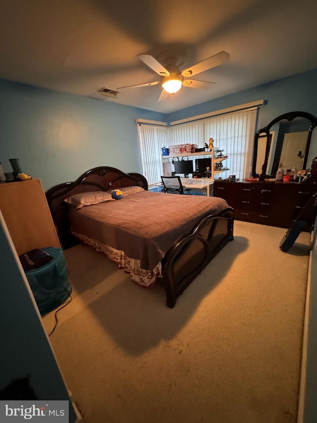 bedroom with ceiling fan and carpet floors