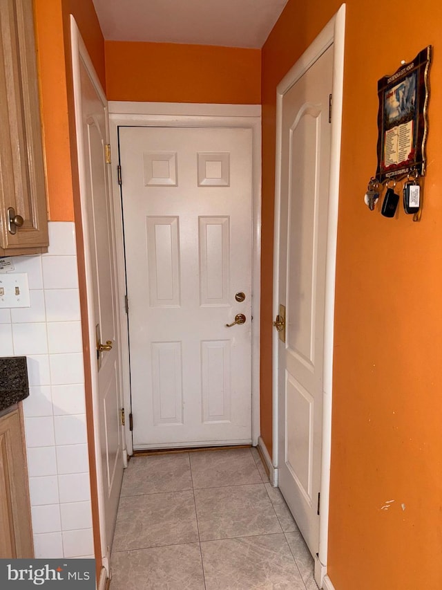 doorway featuring light tile patterned floors