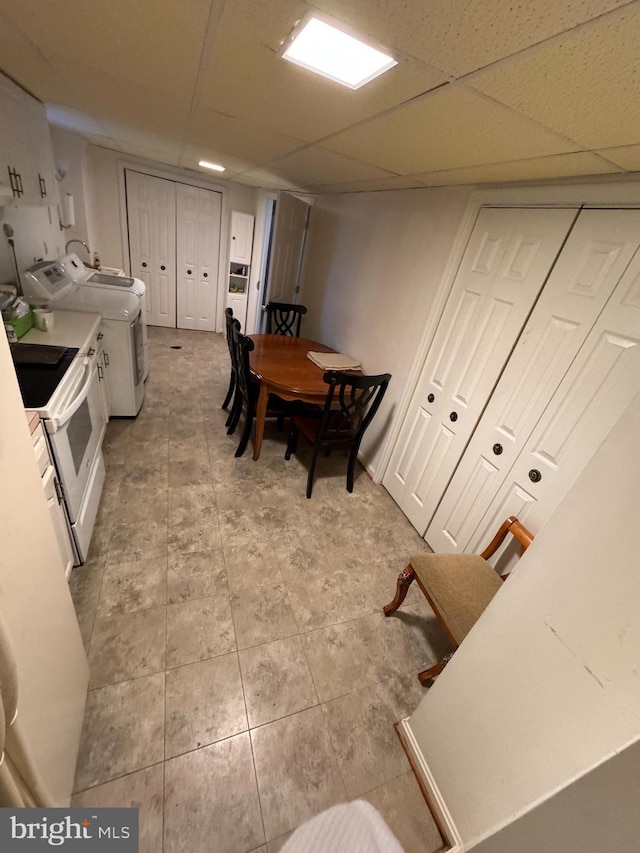 kitchen featuring a paneled ceiling and white electric range