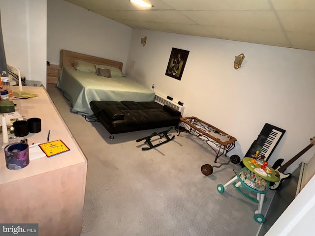 carpeted bedroom with a paneled ceiling