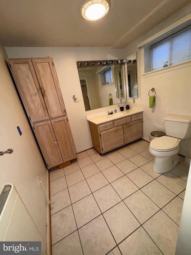 bathroom with tile patterned flooring, vanity, and toilet