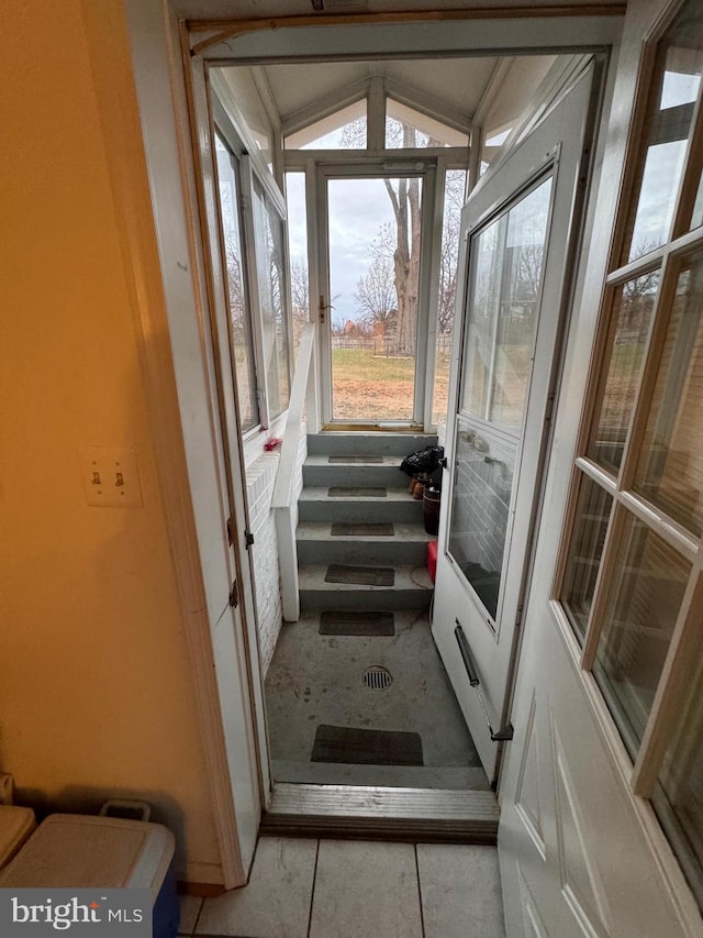 doorway featuring lofted ceiling