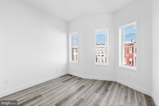 empty room with light hardwood / wood-style floors