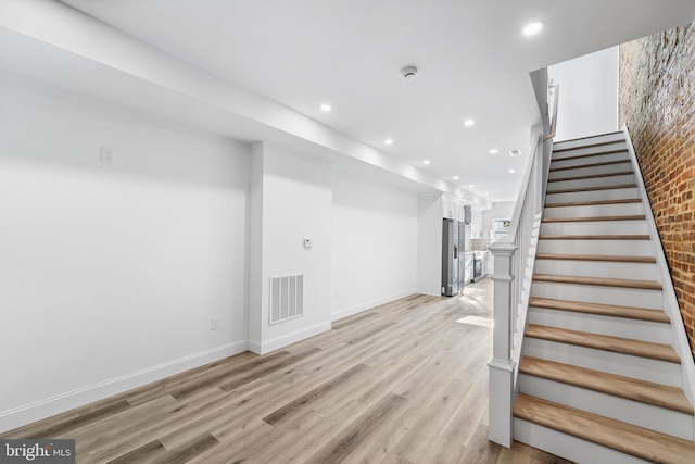 staircase with wood-type flooring