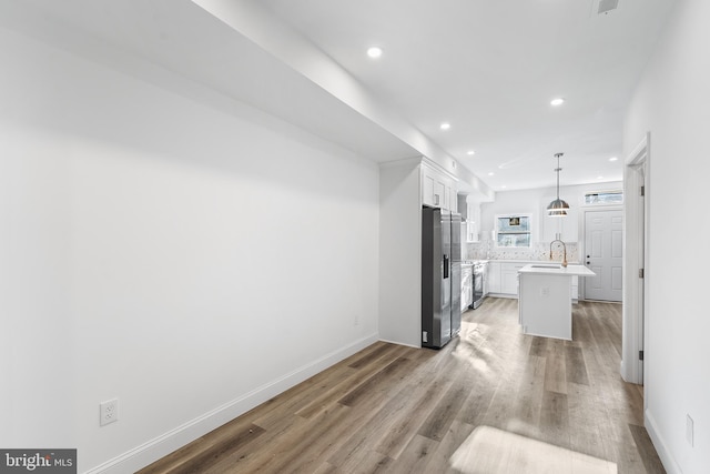 interior space with hardwood / wood-style floors and sink