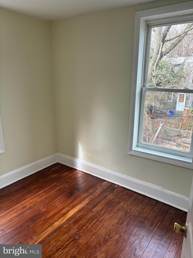 unfurnished room with hardwood / wood-style flooring