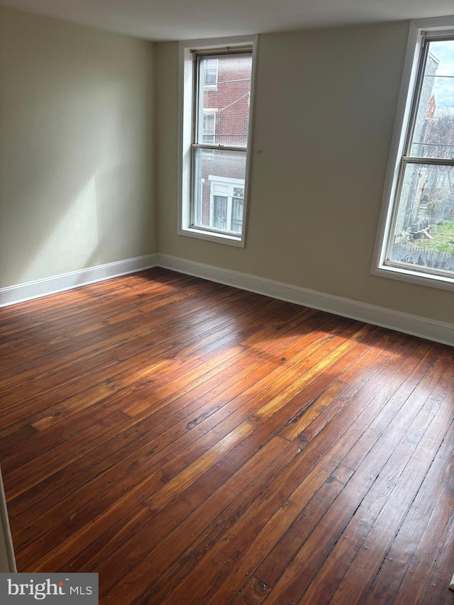 unfurnished room featuring dark hardwood / wood-style floors