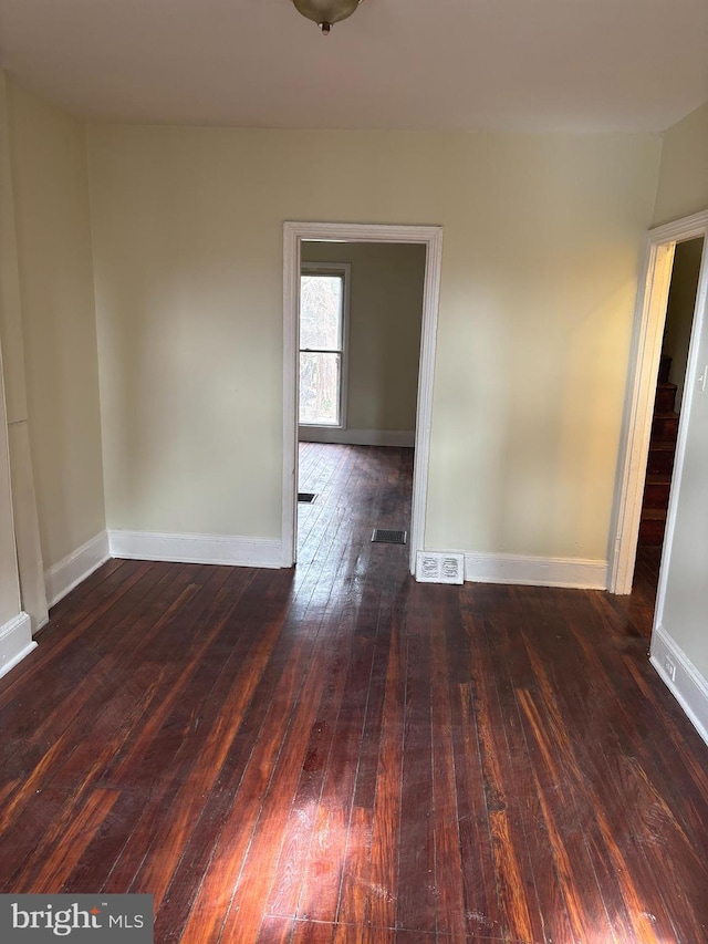 spare room with dark hardwood / wood-style flooring