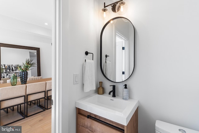 bathroom featuring hardwood / wood-style flooring, vanity, and toilet