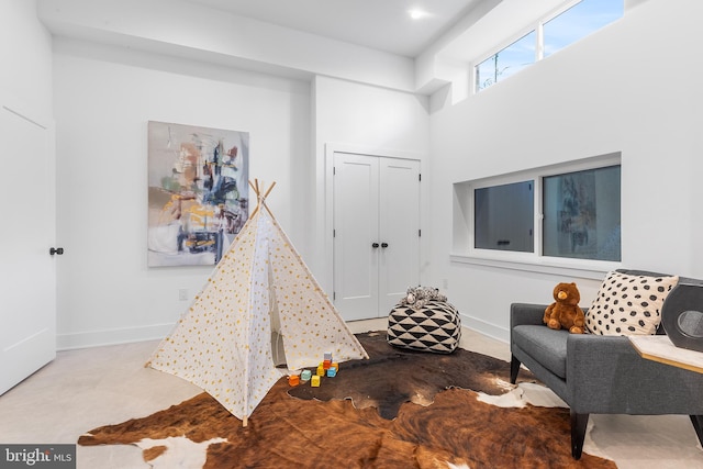 playroom with a high ceiling