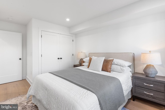 bedroom featuring light hardwood / wood-style flooring and a closet