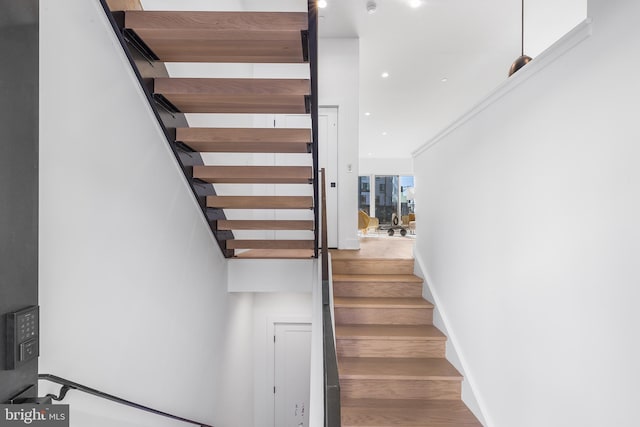 stairs with hardwood / wood-style flooring