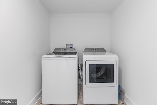 clothes washing area featuring washing machine and clothes dryer