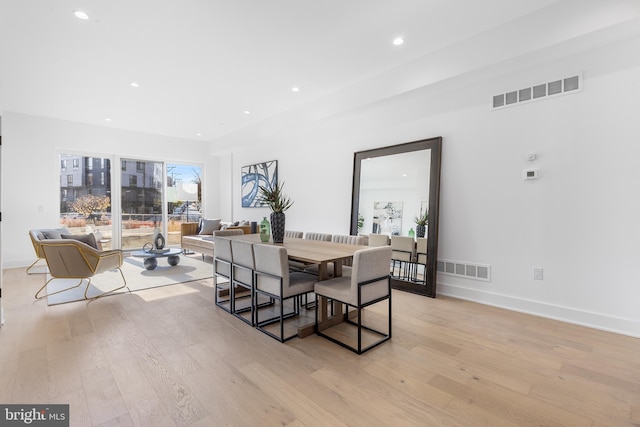 dining space with light hardwood / wood-style floors