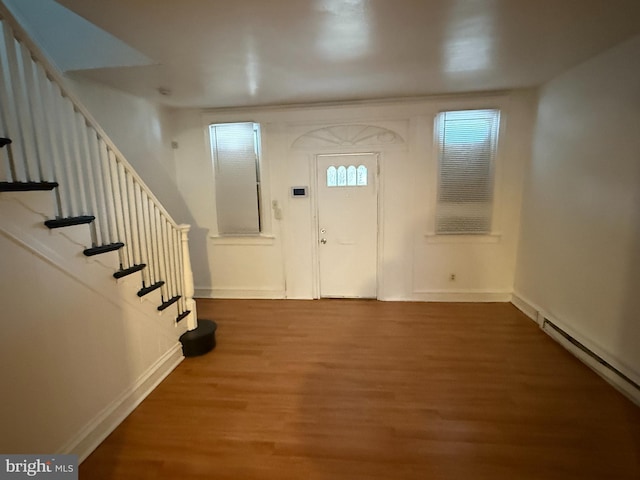 entrance foyer with hardwood / wood-style floors and a baseboard heating unit