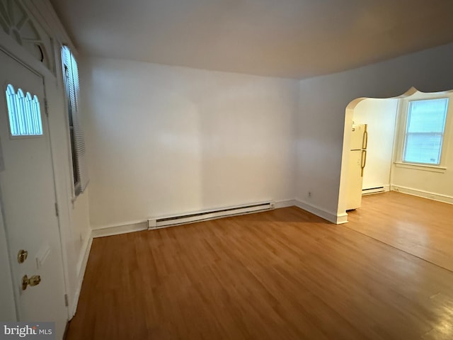 entryway with hardwood / wood-style floors and a baseboard radiator