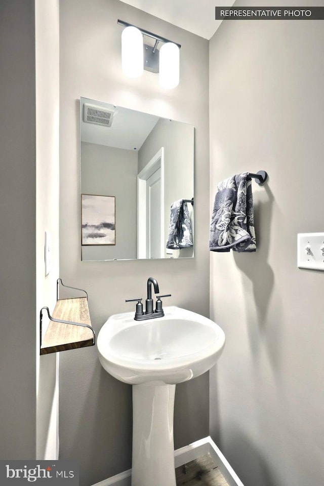 bathroom with hardwood / wood-style flooring and sink