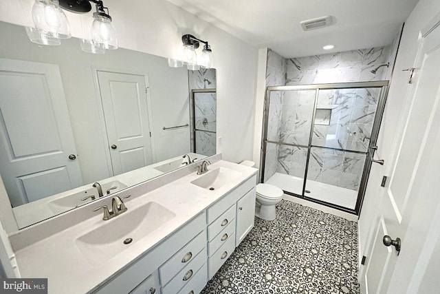 bathroom featuring tile patterned floors, vanity, toilet, and walk in shower