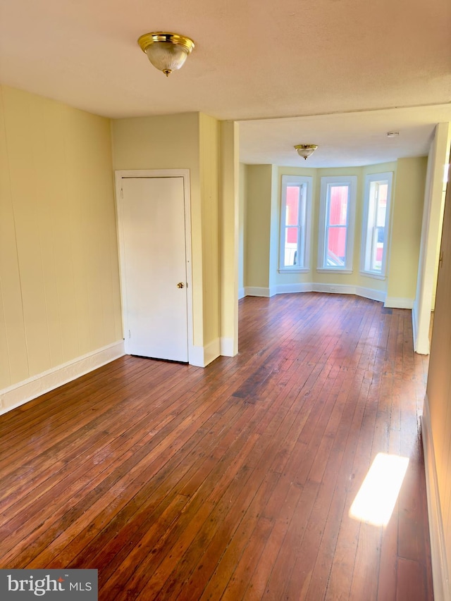 spare room featuring dark hardwood / wood-style floors