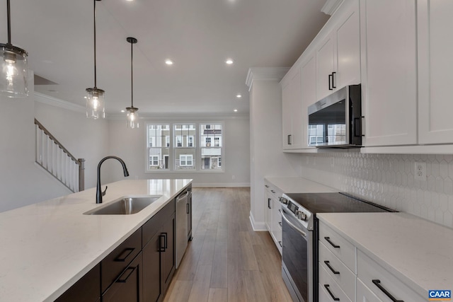 kitchen with white cabinetry, sink, and appliances with stainless steel finishes