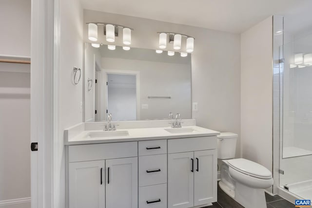 bathroom featuring vanity, toilet, and walk in shower