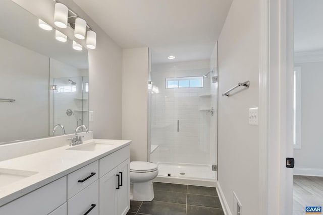 bathroom featuring tile patterned flooring, vanity, toilet, and an enclosed shower