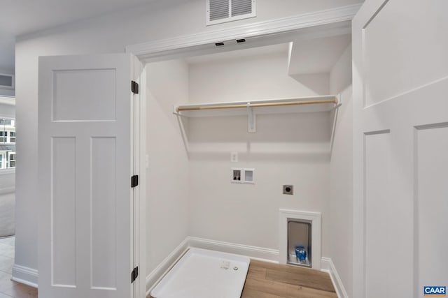 laundry room featuring electric dryer hookup, hookup for a washing machine, and light wood-type flooring