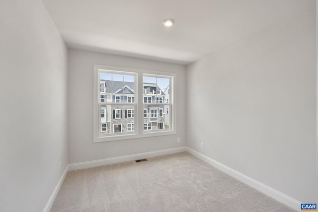 empty room featuring light carpet