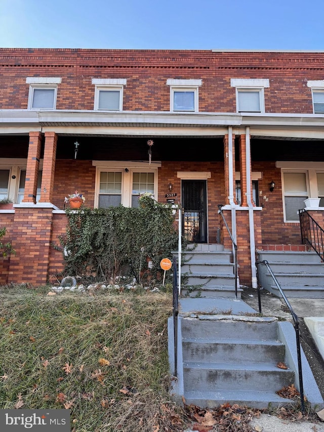 view of property featuring covered porch