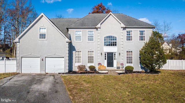 view of front of home with a front lawn and a garage