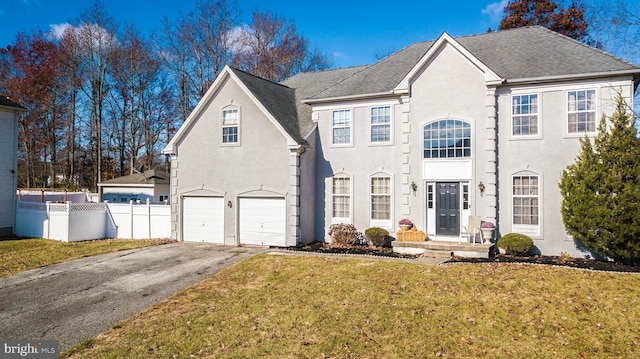 front of property featuring a front lawn and a garage