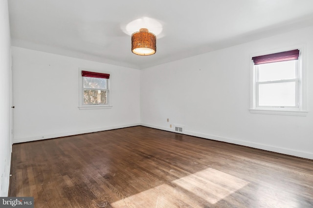 spare room with hardwood / wood-style flooring