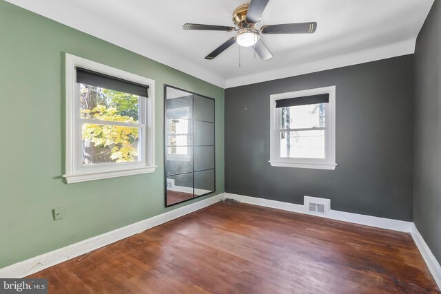 empty room with hardwood / wood-style flooring and ceiling fan