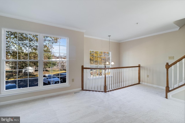 hall with carpet floors, ornamental molding, and an inviting chandelier