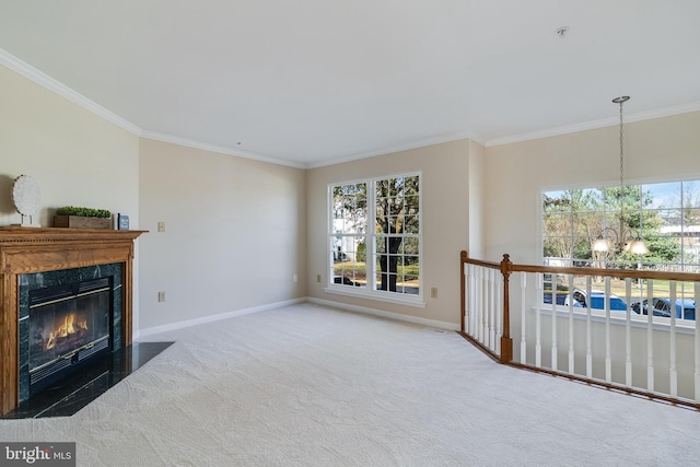 living room featuring carpet flooring, plenty of natural light, ornamental molding, and a premium fireplace