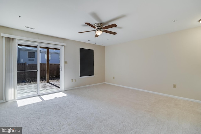 unfurnished room with ceiling fan and light carpet