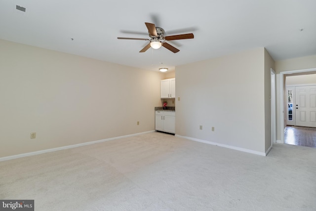 carpeted empty room featuring ceiling fan