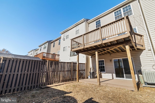 rear view of house with a deck and central air condition unit