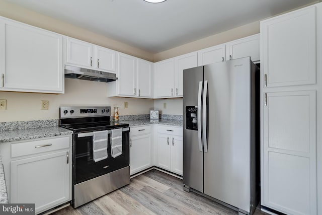 kitchen featuring light stone countertops, appliances with stainless steel finishes, light wood-type flooring, and white cabinetry