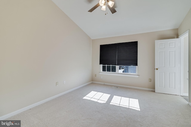 carpeted empty room with ceiling fan and vaulted ceiling