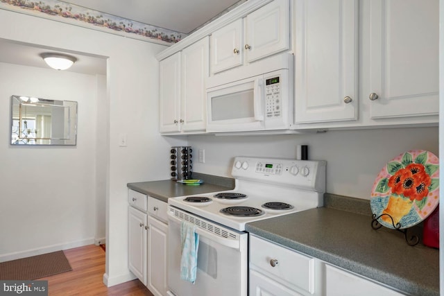 kitchen with white cabinetry, light hardwood / wood-style flooring, and white appliances