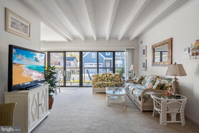 carpeted living room featuring beamed ceiling, a textured ceiling, and a wealth of natural light