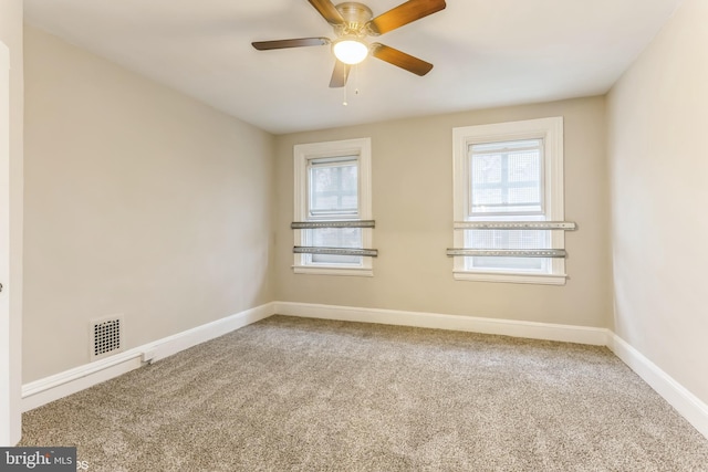 spare room with carpet, plenty of natural light, and ceiling fan