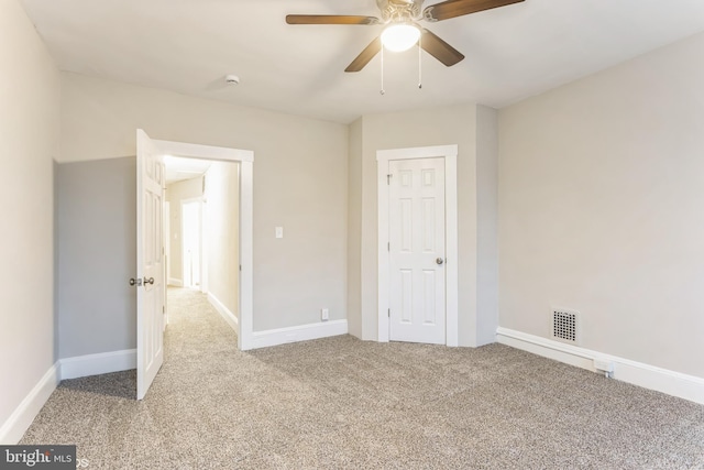 unfurnished bedroom featuring light carpet and ceiling fan