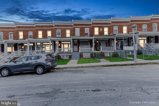 817 Belgian Ave, Baltimore, MD 21218 - view of property featuring covered porch and brick siding