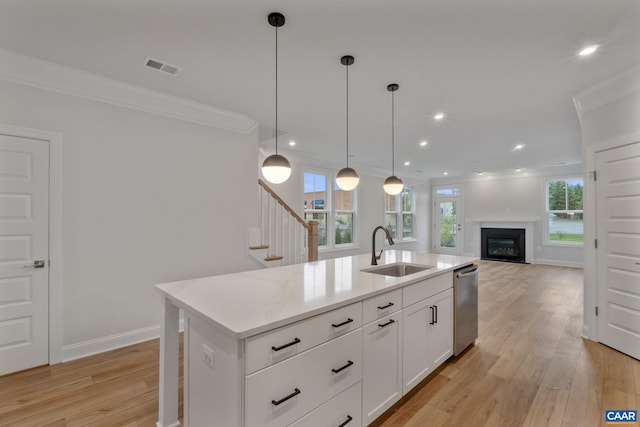 kitchen featuring a center island with sink, plenty of natural light, sink, and decorative light fixtures